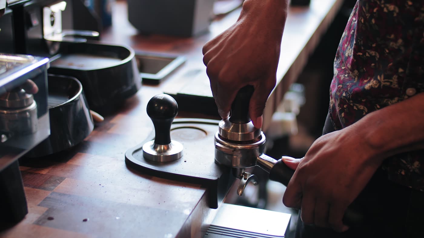 Barista tamping espresso